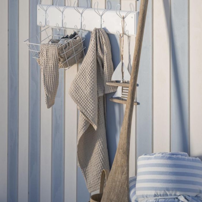 Ib Laursen Beige Liseleje håndklæde 50x100 cm hængende på knagerække på blå/hvid væg